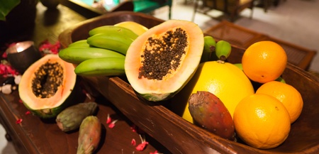 Colorful fruit basket with papaya cut in halfの写真素材