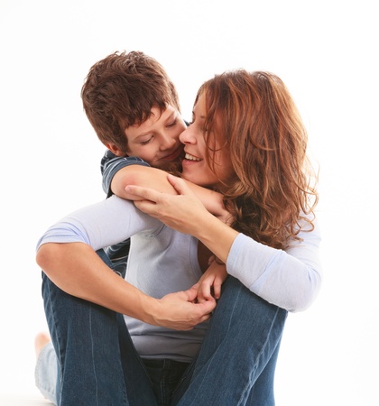 Mother and son in a loving pose isolated on a white background の写真素材