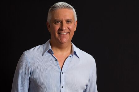 Handsome middle age man on a black background の写真素材