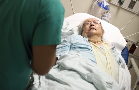 Elderly 80 plus year old woman in a hospital bed の写真素材