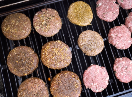 Hamburger patties grilling outdoors on a gas barbeque grill の写真素材