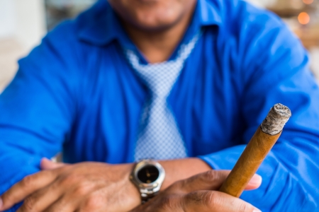 Man smoking a cigar outdoors.の写真素材