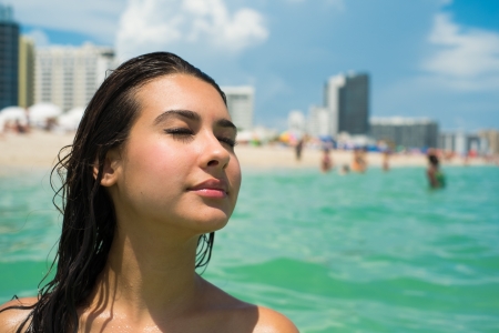 Beautiful young multicultural woman enjoying at the beach の写真素材