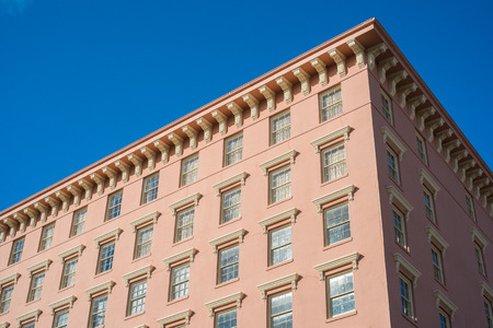 Vintage apartment building against a blue sky.