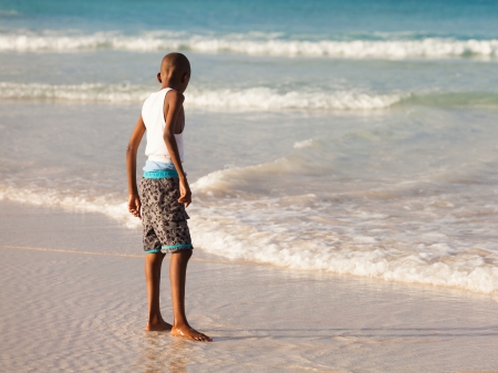 Young boy enjoying the beauty of a Barbados beach.の写真素材