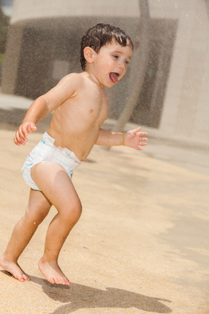 Cute young boy having fun in a park setting.の写真素材