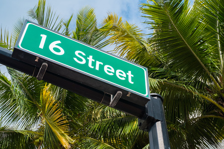 Sixteen street street sign with coconut palm trees in Miami Beach の写真素材