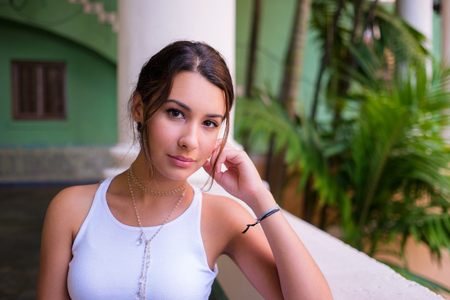 Beautiful young woman in a outdoor courtyard setting.の写真素材