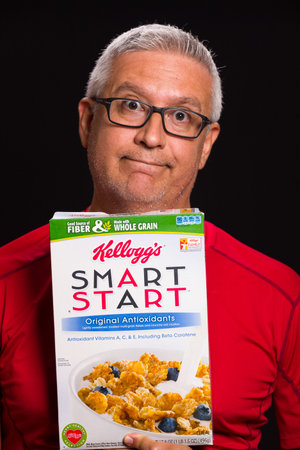 MIAMI, FLORIDA USA - FEBRUARY 4, 2014: Photo of a handsome middle age man holding a box of Kellogg