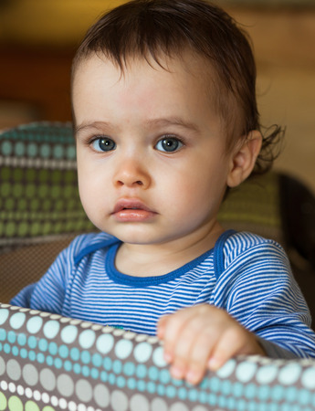 Close up portrait of a cute baby boy with blue eyes.の写真素材