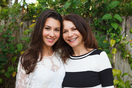 Mother and daughter portrait in a outdoor setting. Mother and daughter portrait in a outdoor setting.
