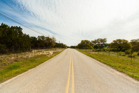 Long winding road with ranches in the Texas Hill Country.の写真素材