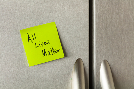 Social commentary on a sticky note on a home refrigerator.の写真素材