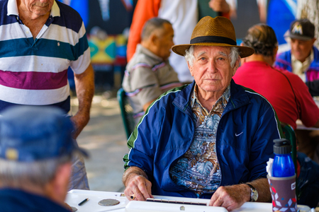Miami, FL USA - January 11, 2017: Unidentified elderly man plays the domino game in the historic Domino Park in popular Little Havana.のeditorial素材