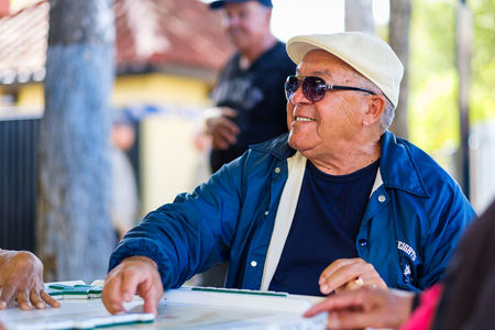 Miami, FL USA - January 11, 2017: Unidentified elderly man enjoying the domino game in the historic Domino Park in popular Little Havana.のeditorial素材