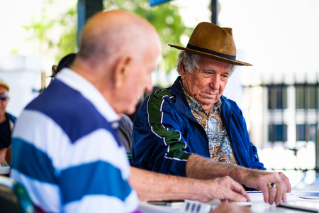 Miami, FL USA - January 11, 2017: Unidentified elderly man plays the domino game in the historic Domino Park in popular Little Havana.のeditorial素材