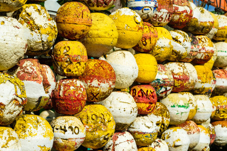 A large collection of marine styrofoam buoy floats hanging by a marina.のeditorial素材