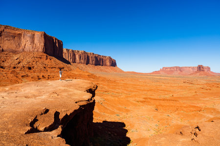 Monument Valley, Utah USA - November 2, 2016: A visitor enjoying the natural beauty of the red sandstone buttes in this popular tourist destination.のeditorial素材