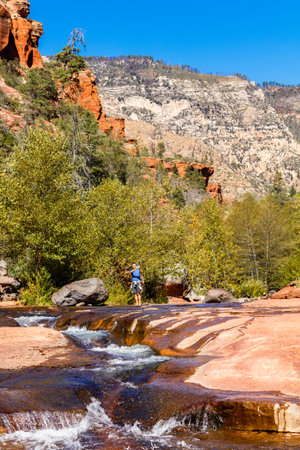 Coconino, AZ USA - October 17, 2016: Visitors enjoying the beauty of Slide Rock State Park with its natural rock water slides in the Oak Creek Canyon near Sedona.のeditorial素材
