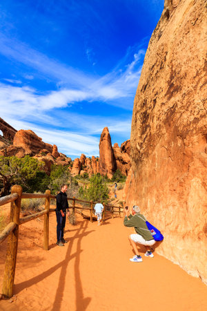 Utah, USA - November 4, 2016: Visitors enjoying the beauty of Arches National Park with over 2,000 natural sandstone arches and numerous hiking trails near Moab.のeditorial素材