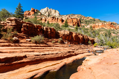 Coconino, AZ USA - October 17, 2016: Visitors enjoying the beauty of Slide Rock State Park with its natural rock water slides in the Oak Creek Canyon near Sedona.のeditorial素材