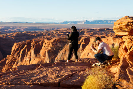 Page, Arizona USA - October 25, 2016: Visitors enjoying the natural beauty of Horseshoe Bend in the late afternoon sun.のeditorial素材