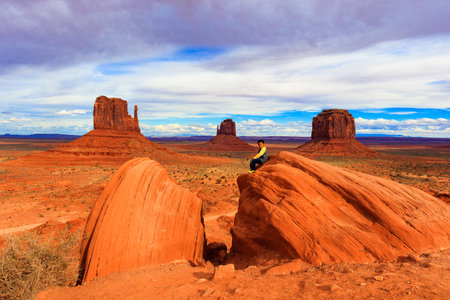 Monument Valley, Utah USA - November 1, 2016: A young native indian boy enjoying the natural beauty of this magnificent desert landscape in the late afternoon.のeditorial素材