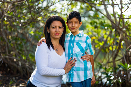 Mother and son outdoor lifestyle portrait in a park setting.の写真素材