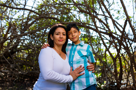 Mother and son outdoor lifestyle portrait in a park setting.の写真素材