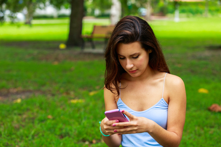 Beautiful young woman outdoor portrait in a park setting.の写真素材