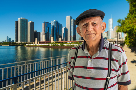 Elderly 80 plus year old man outdoor portrait with the Chicago skyline in the background.