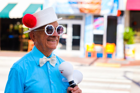 Miami, Florida - February 12, 2018: Unidentified elderly street performer in costume holding maracas along Southwest eight street in popular Little Havana.のeditorial素材