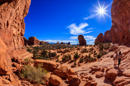 Visitors enjoying the natural beauty of the Double Arch rock formation in Arches National Park.のeditorial素材