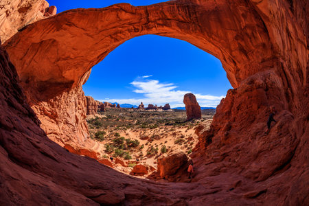 Visitors enjoying the natural beauty of the Double Arch rock formation in Arches National Park, Utah.のeditorial素材