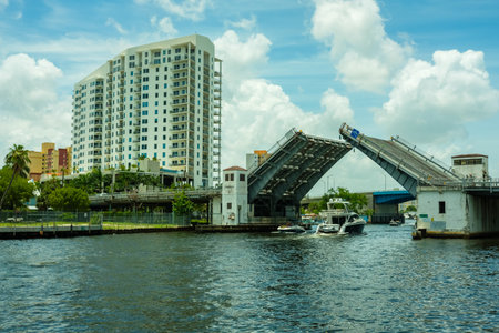 Miami, Florida USA - July 8, 2018: Scenic Miami River cityscape with boats cruising under the West Flagler Street drawbridge.のeditorial素材