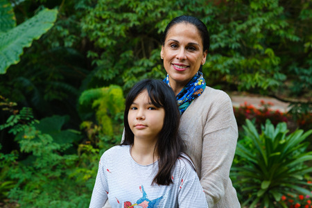 Mother with pre teenage daughter outdoor portrait.の写真素材