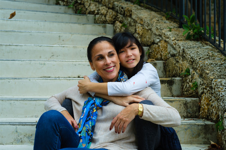 Mother with pre teenage daughter outdoor portrait.の写真素材
