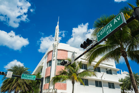 Miami Beach, Florida USA - March 4, 2019: Cityscape view of the classic art deco hotel architecture with palm trees along popular Collins Avenue.のeditorial素材