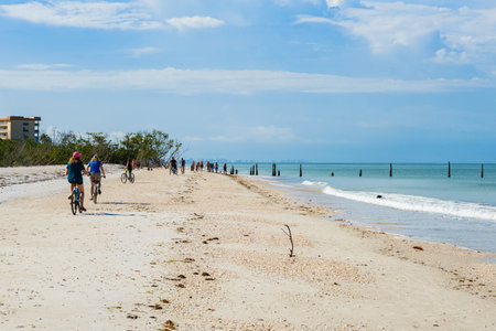 Fort Myers, Florida USA - May 7, 2019: Visitors enjoying a morning bike ride along popular Fort Myers Beach on the west coast of Florida.のeditorial素材