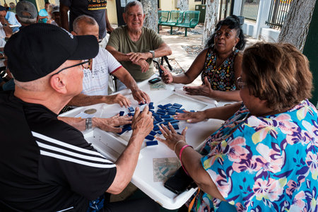 Miami, Florida USA - July 22, 2019: Elderly individuals play the domino game in the historic Domino Park in popular Little Havana.のeditorial素材