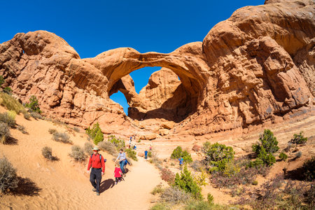 Moab, Utah USA - October 19, 2019: Tourists enjoying the natural beauty of the Double Arch in Arches National Park.のeditorial素材