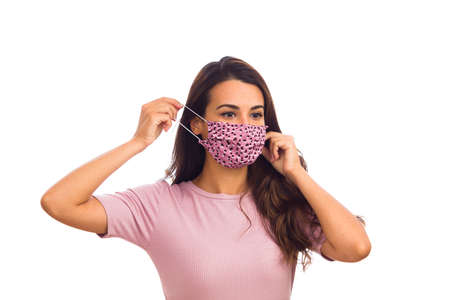 Beautiful young woman portrait wearing a mask on a white background.