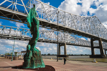 New Orleans, Louisiana USA - September 30, 2019: Cityscape of the Interstate 10 Twin Span Bridge over the Mississippi River and the Mother River statue.のeditorial素材