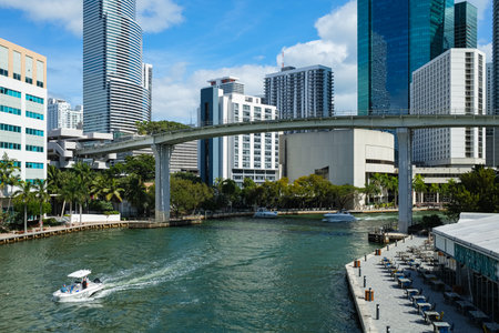 Miami, Florida USA - January 30, 2021: Downtown skyline cityscape with tall skyscrapers and boats cruising the river in the Brickell district.のeditorial素材