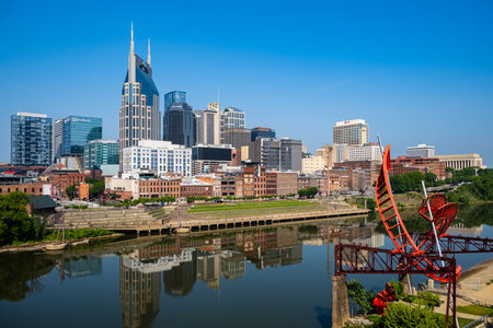 Nashville, Tennessee USA - May 12, 2023: Downtown skyline view from the vintage John Seigenthaler Pedestrian Bridge over the Cumberland Riverのeditorial素材