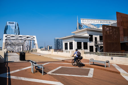 Nashville, Tennessee USA - May 12, 2023: Downtown skyline view from the vintage John Seigenthaler Pedestrian Bridge over the Cumberland Riverのeditorial素材