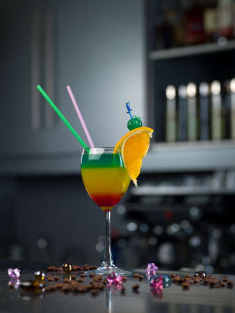 glass with a cocktail and a slice of lemon is on the barの写真素材