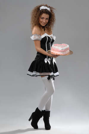 beautiful woman waiter holding a tray of cakeの写真素材