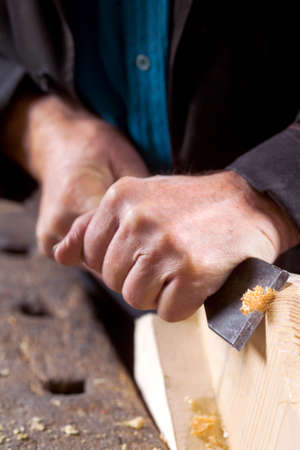 hands working with a tool for processing boards