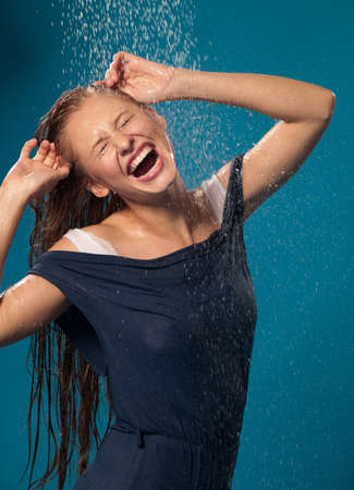 woman in a bathing suit and a jet of waterの写真素材